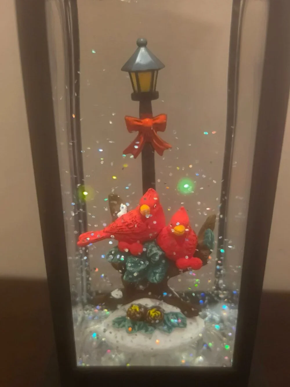 Black Cardinal Snow Globe Lantern is a traditional style LED lighting decoration